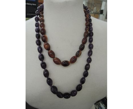 A string of graduated amethyst beads and a string of graduated brown horn beads