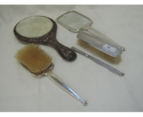 A silver three piece dressing table set having engine turned decoration and plain cartouche, Birmingham 1920, Adie Brothers, 