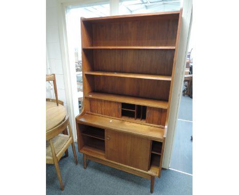 A 1960's design teak full height sideboard having upper shelf and tambour section over sliding cupboards, by BM Denmark