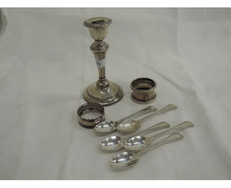 A selection of HM silver including six teaspoons, two napkin rings and a candlestick