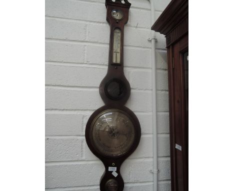 An early 19th century George III mahogany wheel barometer having humidity and thermometer scales, with level marked B Porri S