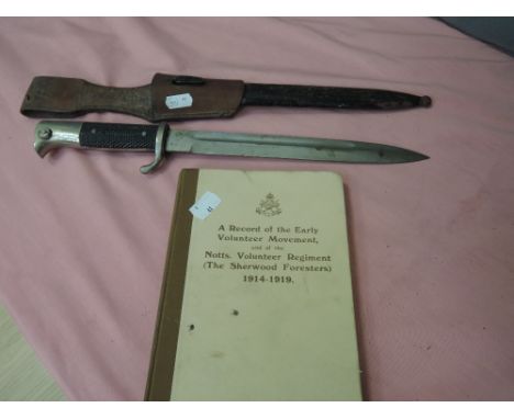 A German World War I Mauser bayonet with scabbard, plus a record of the early volunteer movement book