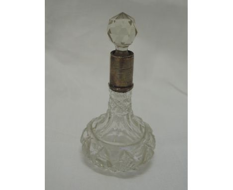 A small cut glass perfume bottle of ships decanter form having HM silver collar, marks worn 
