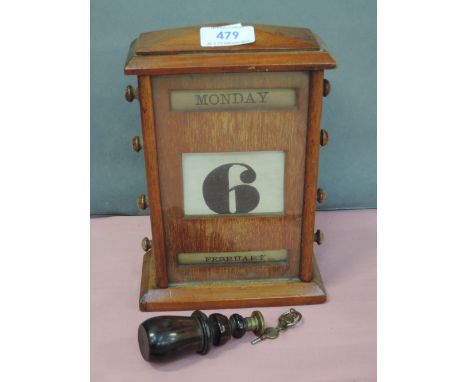 An Edwardian light mahogany day date calendar, a treen turned handle seal and watch keys