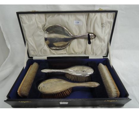 A cased five piece silver dressing table set of plain form having monogram 'JW', Chester 1921/22, J & R Griffin