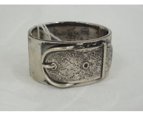 A white metal hinged bangle having appliqué buckle with foliate  decoration, no marks 