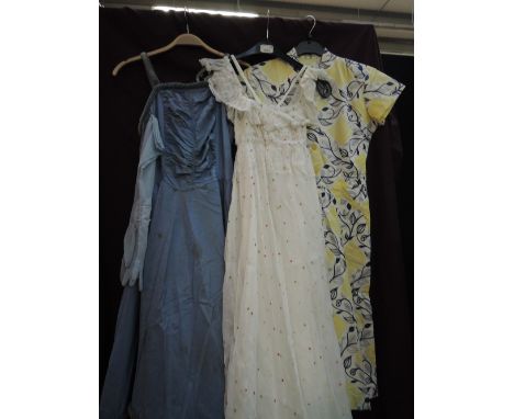 A ladies vintage pale blue evening dress having ruched bodice with velvet straps and full skirt with velvet decoration, with 