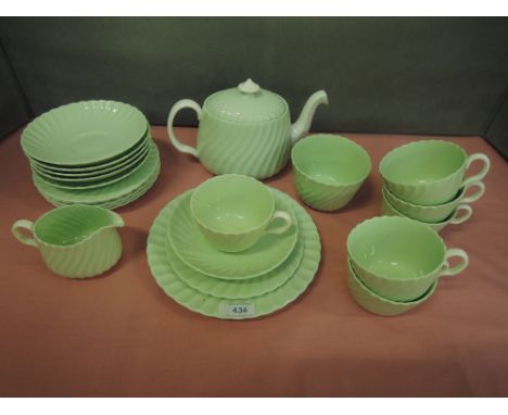 A Mintons tea service of wrythen form having celadon green ground 