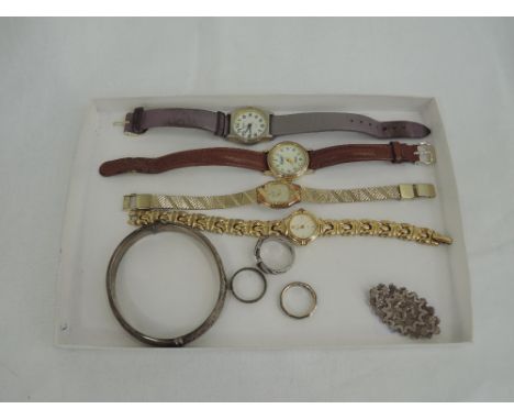 A selection of HM silver jewellery and costume wrist watches including hinged bangle, ring modelled as a belt, Isle of man br