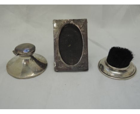 A small silver capstan inkwell of plain form, Birmingham 1910, makers marks worn, an Edwardian silver pen brush, Birmingham 1