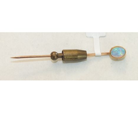 An Edwardian stick pin set an oval opal, in 15ct gold mount.