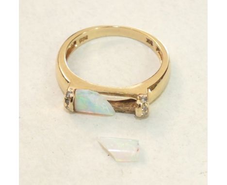 A modern 14ct yellow gold ring set opal baton, (a/f, in two pieces), between diamond-set shoulders, size N½, 2.6g.