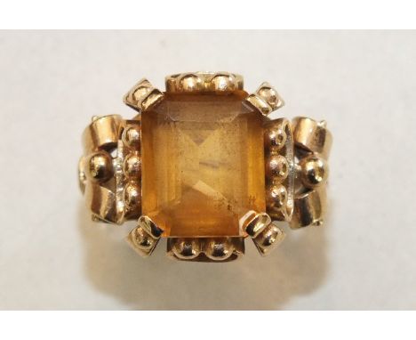 A 9ct gold ring set citrine, in scrolling mount, size K½, 6.5g.