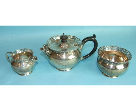 An Edwardian Irish three-piece bachelor's tea service, with pierced engraved rim, dolphin handle and spouts, stamped "West &a