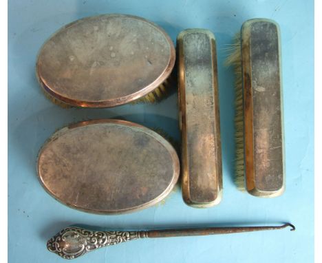 A pair of Art-Deco-style silver-backed hair brushes, London 1913, a similar pair of clothes brushes, London 1919 and a silver