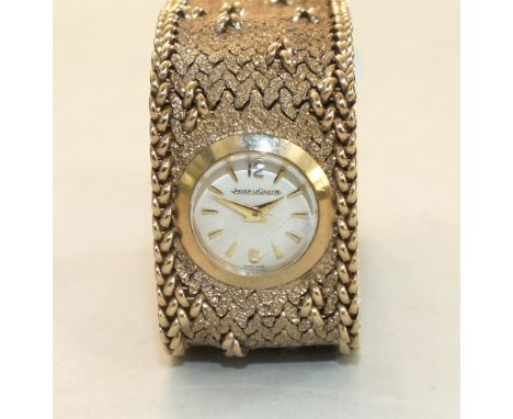 Jaeger LeCoultre, a ladies 9ct gold wrist watch, the circular dial with Arabic and dart numerals set in a textured flexible b