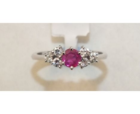 A ruby and diamond cluster ring claw-set a round-cut ruby between two triplets of brilliant-cut diamonds, in 18k white gold m