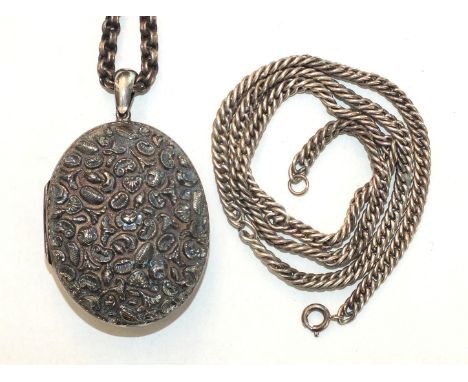 A large white metal locket embossed on both sides with flowers, leaves and shells, and two chains, (3).