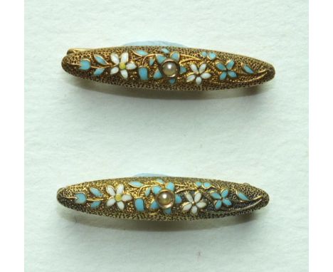 A pair of small 14k gold brooches, each set a seed pearl within enamelled floral decoration, 24mm long, 2.4g, (2).