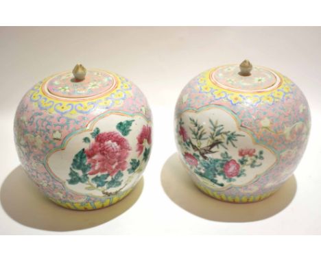 Pair of Chinese porcelain jars and covers with famille rose decoration within panels, surrounded by blue scroll work on a pin