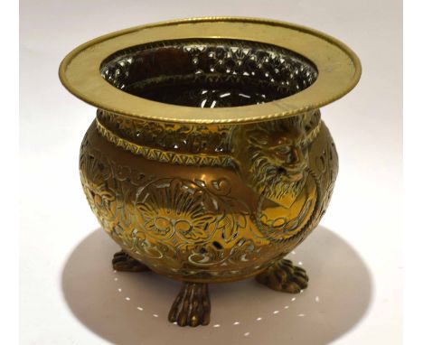 Victorian brass jardiniere applied on either side with lion mask ring handles and with pierced border, decorated with scrolls