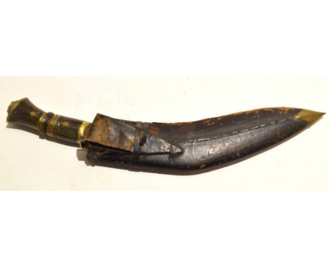 Indian manufactured kukri in leather scabbard, the handle with brass mounts  