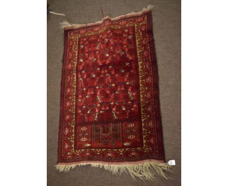 Small Caucasian prayer rug, central panel of architectural and geometric designs, triple gull border, mainly red field, 120cm