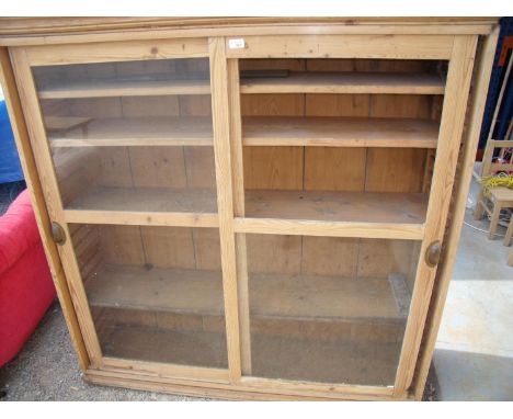 Victorian pine four tier adjustable shelf unit enclosed by two glazed sliding doors (140cm x 35cm x144cm) 