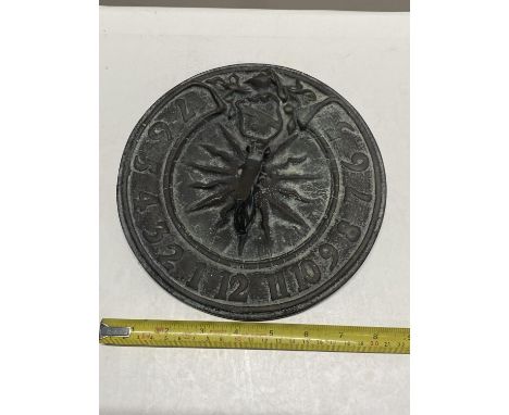 A vintage cast iron sundial.