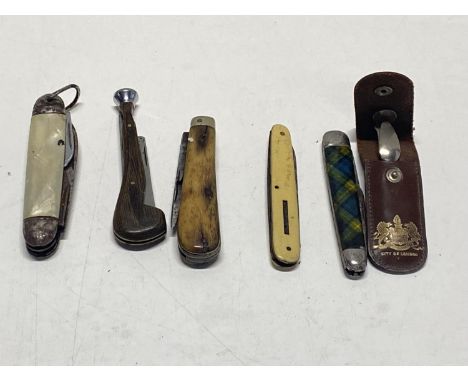 A selection of vintage pen knives and pipe tampers