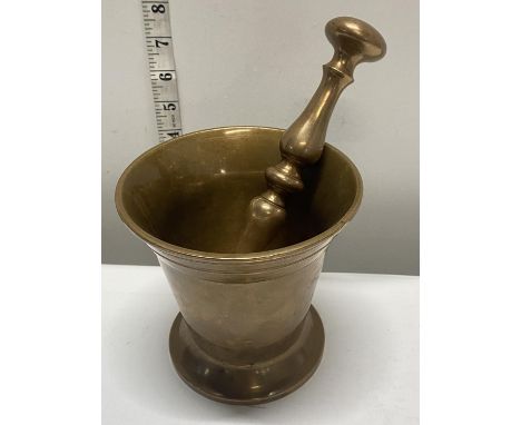 A large heavy brass pestle and mortar