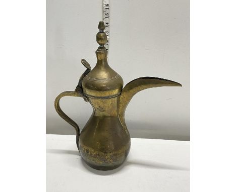 A antique Syrian brass Dallah coffee pot of bulbous form, with hinged lid &amp; decorative finial. Including two callographic