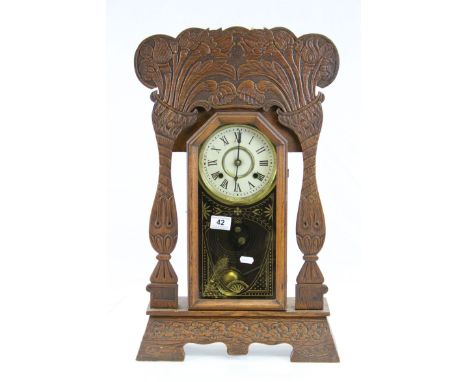 Large carved wood bracket clock with cream enamel with black Roman numerals and poker hands, glazed door and floral decorated