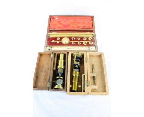 Two Wooden cased Brass Student type Microscopes plus a cased Sikes Hydrometer with slide rule &amp; thermometer