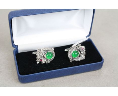 Pair of silver and jade dragon form cufflinks with ruby eyes 