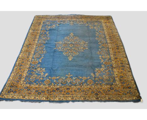 Ushak carpet with pale blue field, west Anatolia, about 1920s, 14ft. 4in. x 11ft. 11in. 4.36m. x 3.63m. Damage lower right co