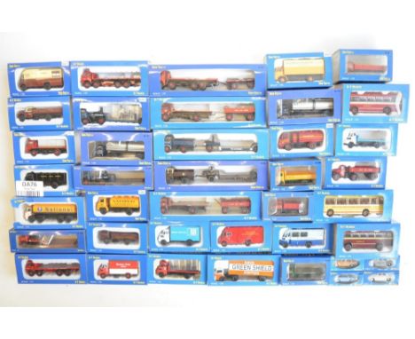 Forty boxed 1/76 scale OO gauge diecast model vehicles from Base-Toys (B-T Models) to include trucks, vans, cars, buses, tank