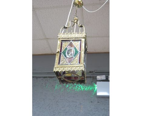 A CONTINENTAL STYLE STAINED GLASS HALL LANTERN the foliate pierced frame fitted with four glazed panels centred by a single p