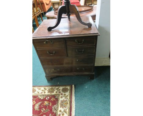 A GEORGIAN STYLE MAHOGANY CUPBOARD the rectangular top with moulded rim above a pair of hinged doors two mock long drawers on