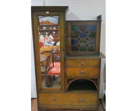 AN ARTS AND CRAFTS WARDROBE the moulded cornice above a rectangular framed plate opening to reveal hanging space and flanked 