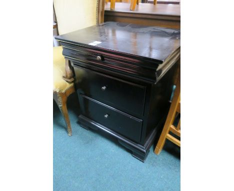 A BLACK PAINTED BEDSIDE LOCKER the rectangular top with single frieze drawer above two deep drawers on shaped bracket feet 70