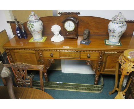 A 19TH CENTURY MAHOGANY SIDEBOARD the raised shaped back above a plain front with molded rim applied with a foliate trim the 