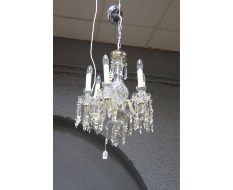 A WATERFORD CRYSTAL SIX LIGHT CHANDELIER the diamond cut reservoir issuing scrolled arms hung with pendant drops