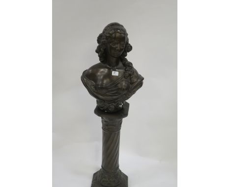 A PAIR OF BROWN PAINTED FEMALE BUSTS shown standing on a spiral turned column base  122cm high