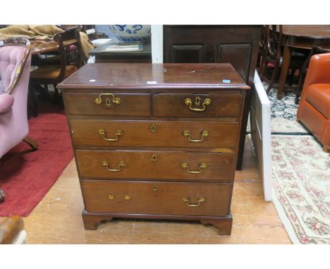 A 19TH CENTURY MAHOGANY CHEST OF DRAWERS the rectangular top with moulded rim above two short and three long drawers with  br