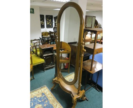 A MODERN MAHOGANY FRAMED CHEVAL MIRROR the moulded frame with bevelled plate between a pair of column uprights on shaped base