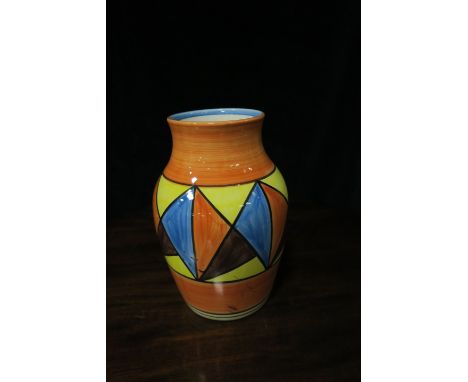 A GLAZED PORCELAIN VASE BY CLARICE CLIFF of circular tapering form the orange ground painted with blue orange and brown trian