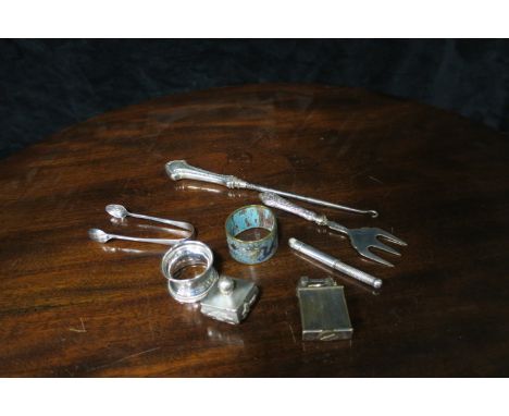 A MISCELLANEOUS COLLECTION including two silver cigarette lighters Parker and Dunhill a silver napkin ring sugar tongs glass 