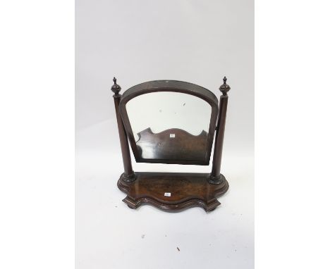 A MAHOGANY DRESSING TABLE MIRROR 19TH CENTURY with arched framed plate supported on column sides with serpentine shaped base 