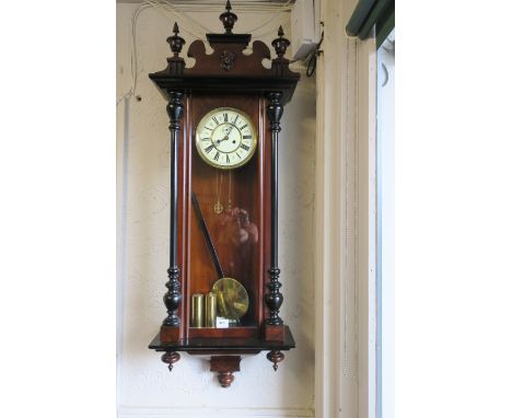 A MAHOGANY CASED WALL MOUNTED CLOCK the cornice headed by classical urns and decorated with a female mask above the glazed fr